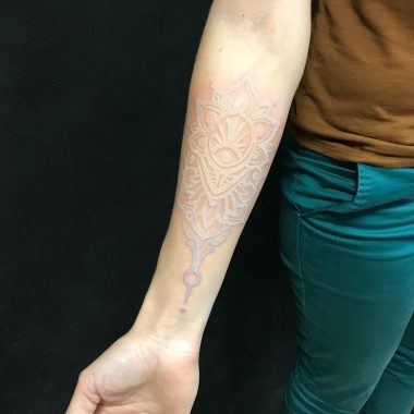 Белая татуировка мандала на руке