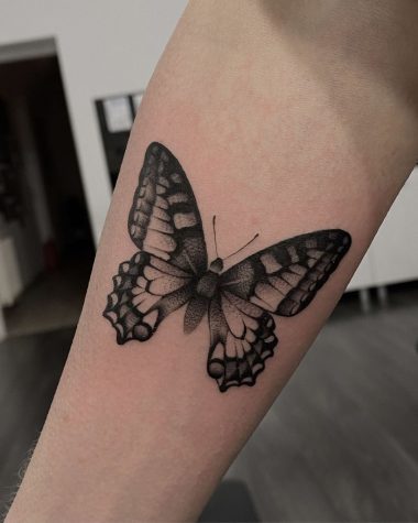 Татуировка бабочка в стиле графика на предплечье у девушки