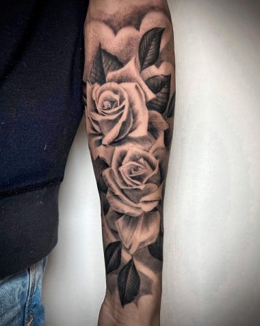 Черно-серая татуировки роз на предплечье у парня