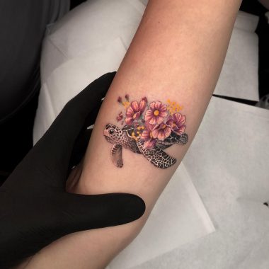 Черепаха с цветами, тату на руке у девушки